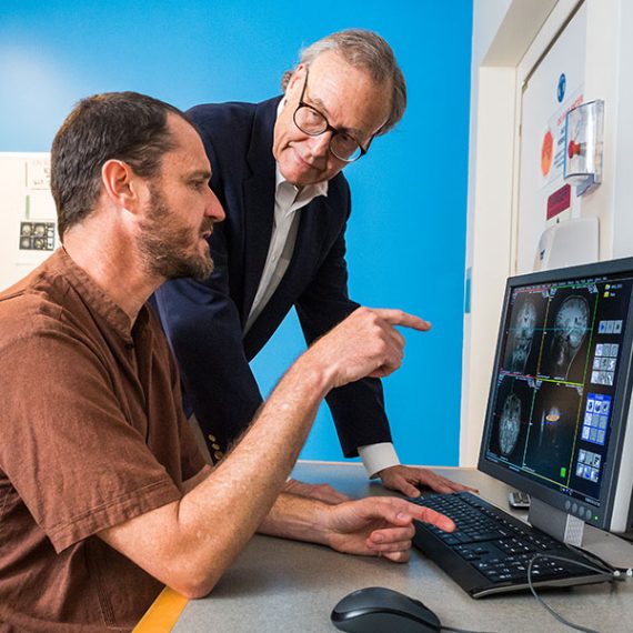 Martinos Imaging Center Director John Gabrieli (right) assists a postdoc with research in the center.