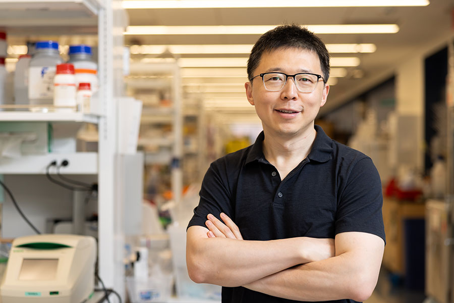 Smiling scientist in a lab setting.