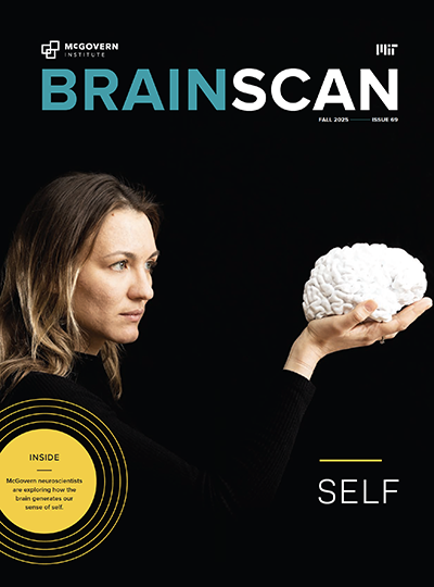 Cover of BrainScan newsletter showing a woman in black holding a 3d printed white brain
