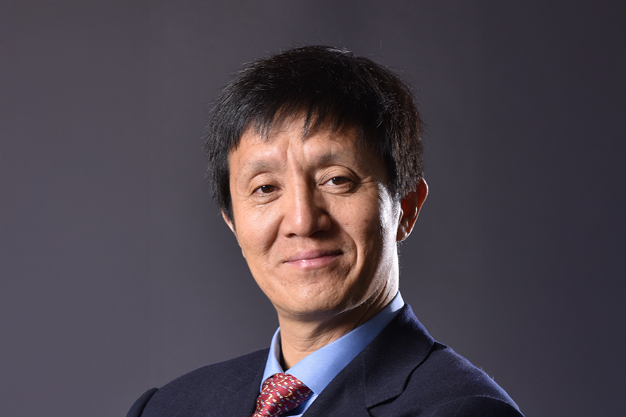 Horizontal portrait of Liqun Luo in a jacket and tie.