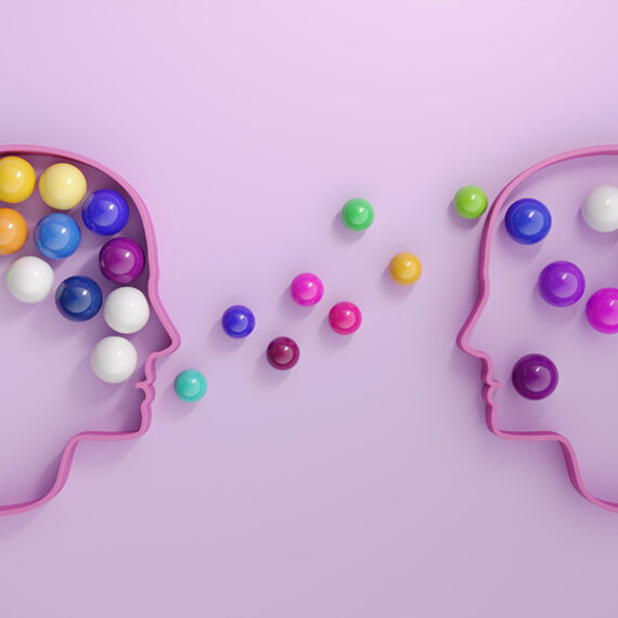 Human heads includes lots of multi colored spheres, symbolizing communication concepts. (3d render)